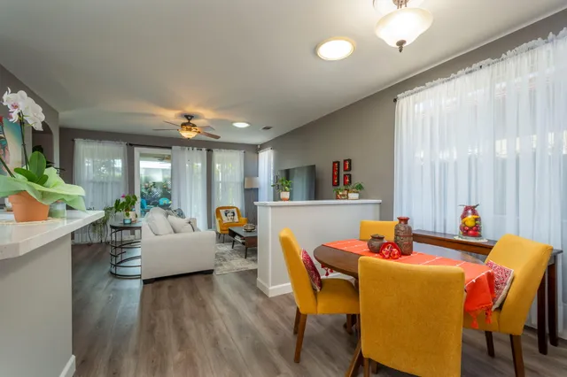 a view of a dining room with furniture and wooden floor