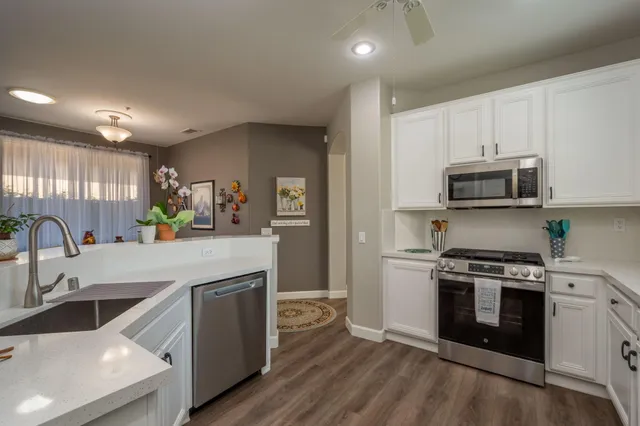 a kitchen with a stove a sink and a microwave