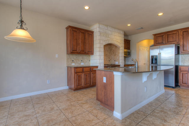 321 Limestone Trail Austin, TX 78737 - Photo 17 of 28 a kitchen with stainless steel appliances granite countertop a stove a sink and a refrigerator