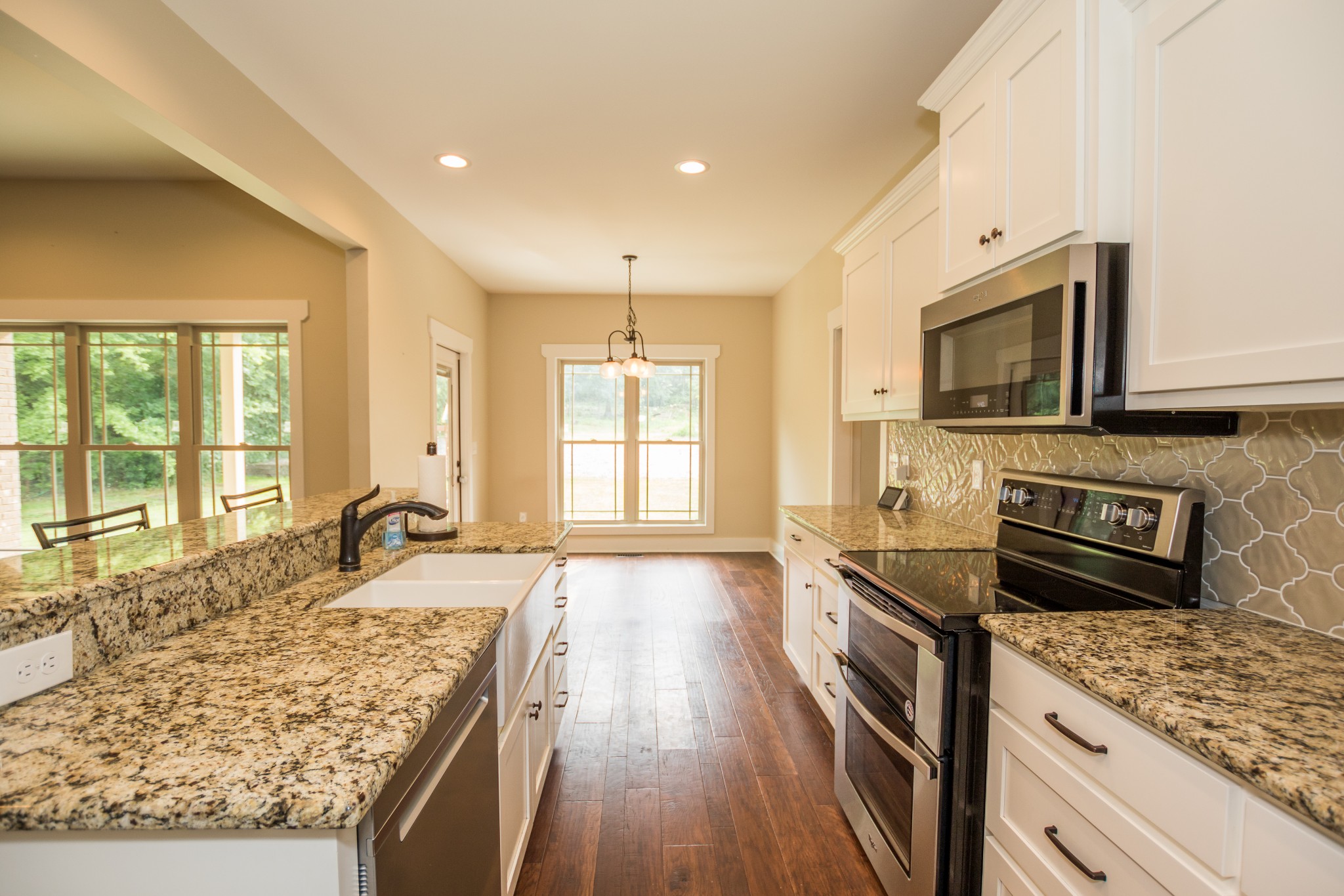 3597 Thompson Road Rockvale, TN 37153 - Photo 6 of 23 a kitchen with granite countertop a sink stove and cabinets