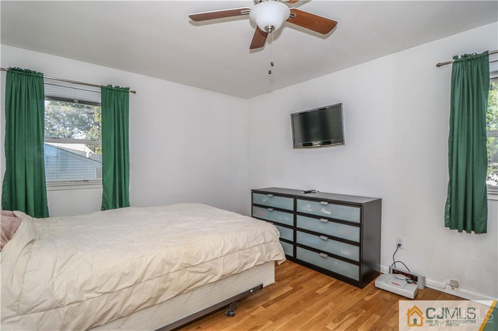 39 Outcalt Road Edison, NJ 08817 - Photo 12 of 17 a bedroom with a bed and a flat screen tv
