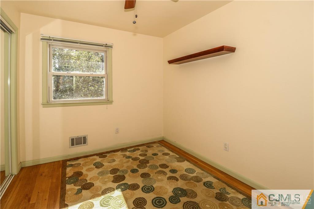39 Outcalt Road Edison, NJ 08817 - Photo 14 of 17 a view of a room with wooden floor and a window