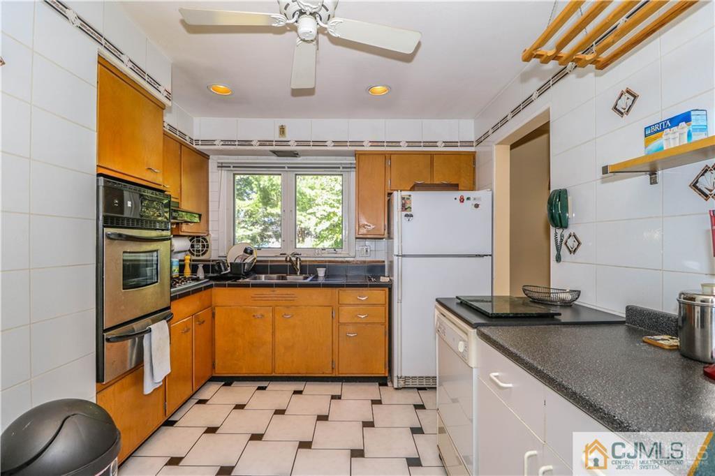 39 Outcalt Road Edison, NJ 08817 - Photo 7 of 17 a kitchen with stainless steel appliances granite countertop a sink and a refrigerator