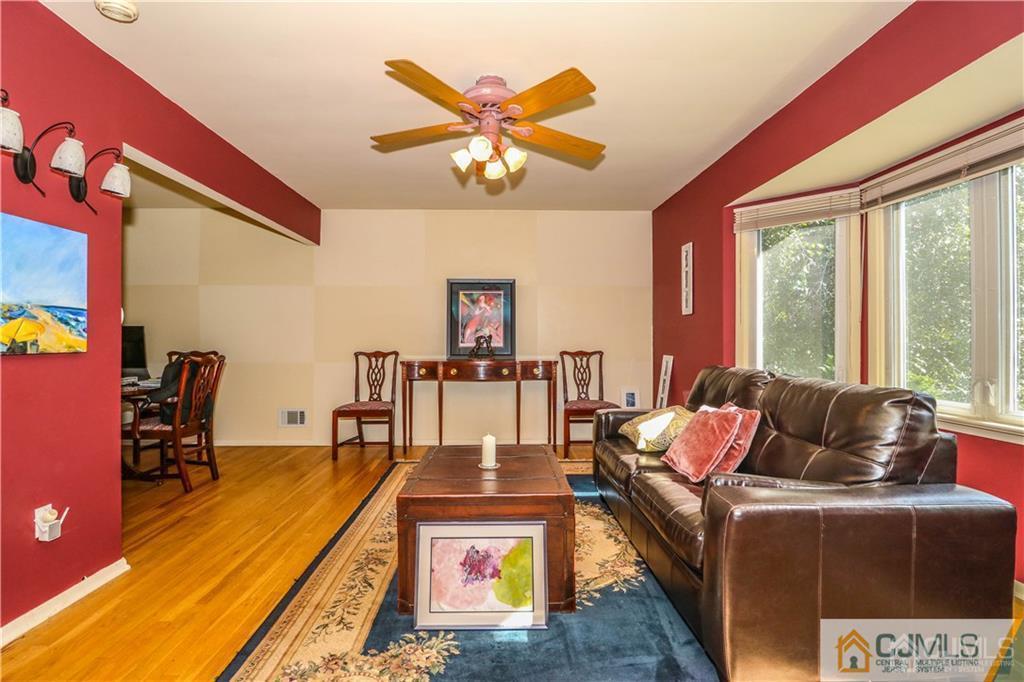 39 Outcalt Road Edison, NJ 08817 - Photo 10 of 17 a living room with furniture a chandelier and a floor to ceiling window