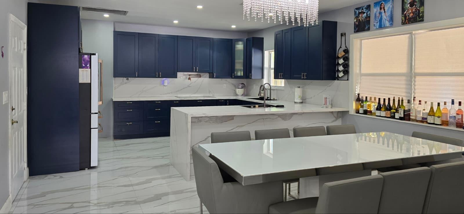 1888 Northwest 75th Way Hollywood, FL 33024 - Photo 19 of 45 a kitchen with kitchen island a sink table and chairs