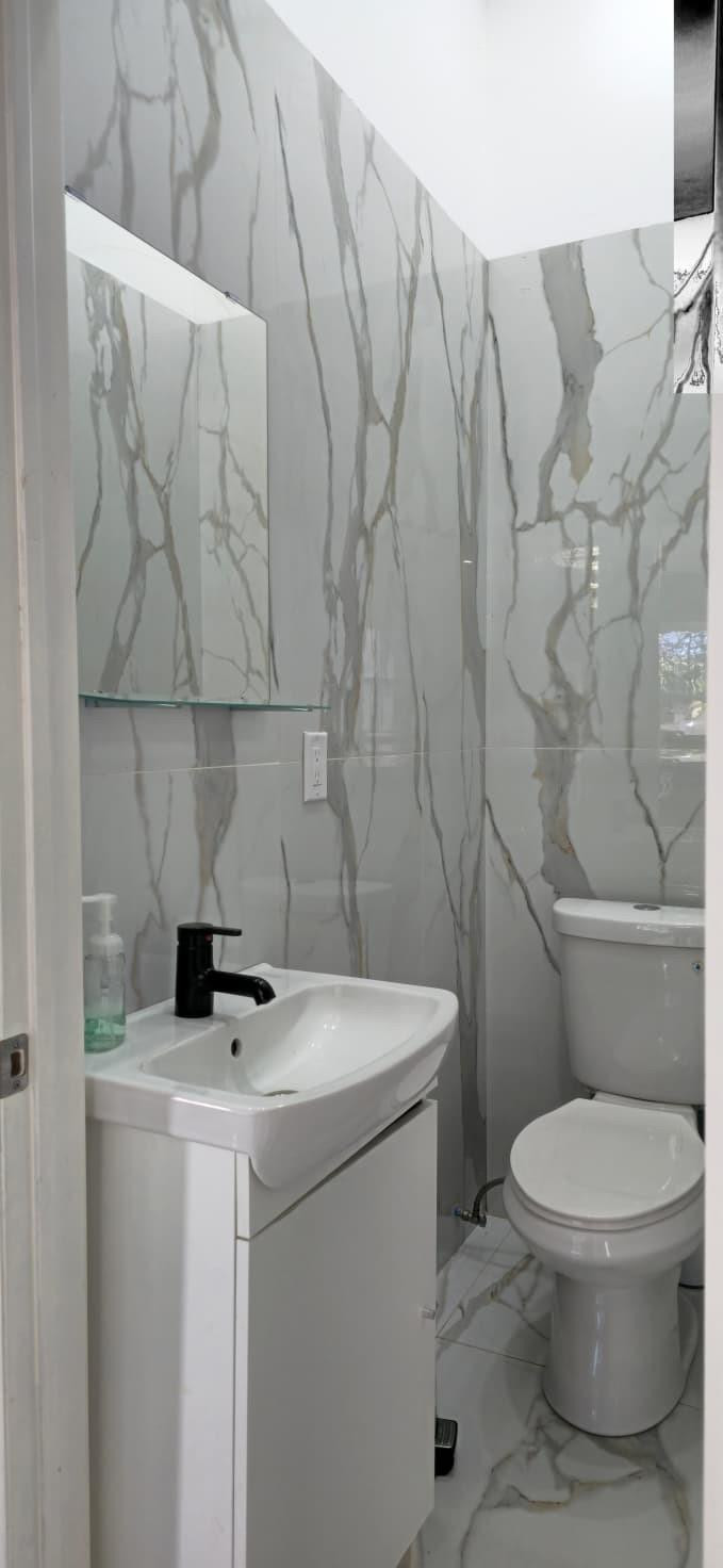 1888 Northwest 75th Way Hollywood, FL 33024 - Photo 25 of 45 a bathroom with a toilet and a sink