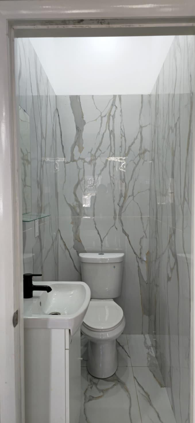 1888 Northwest 75th Way Hollywood, FL 33024 - Photo 26 of 45 a white toilet sitting next to a shower curtain