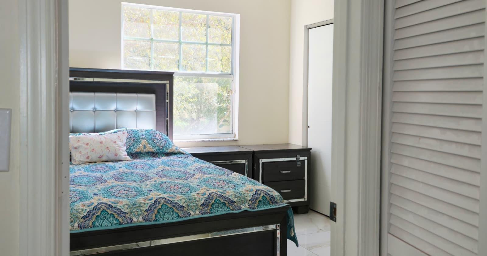 1888 Northwest 75th Way Hollywood, FL 33024 - Photo 28 of 45 a bedroom with a bed and a window