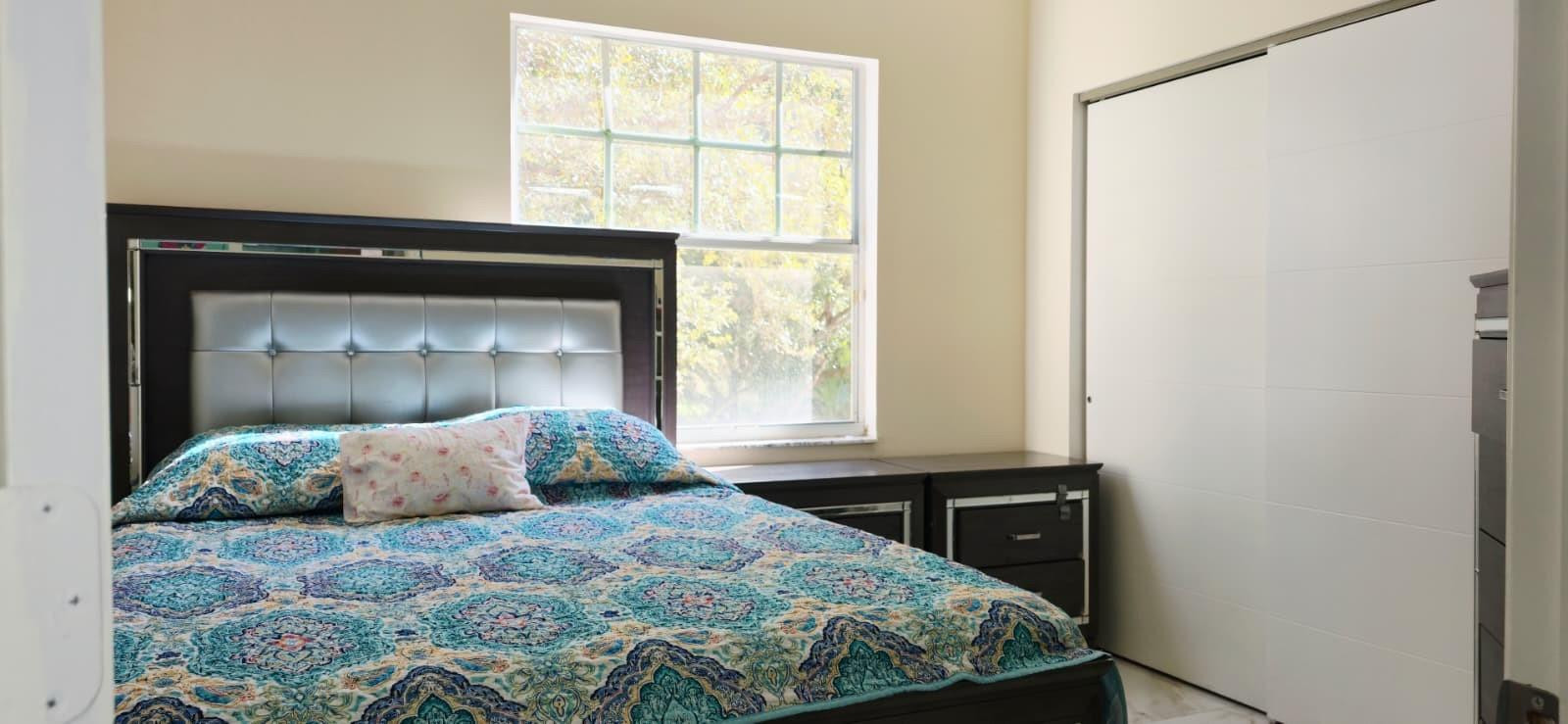 1888 Northwest 75th Way Hollywood, FL 33024 - Photo 29 of 45 a bedroom with a bed and a window