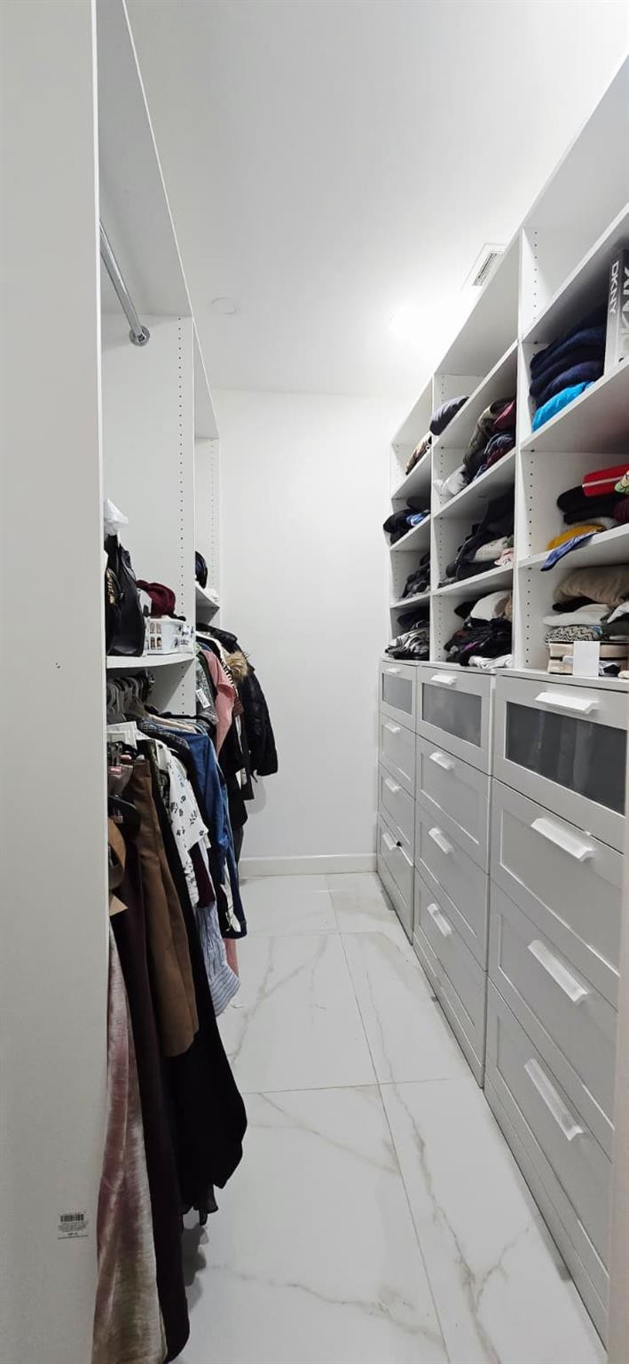 1888 Northwest 75th Way Hollywood, FL 33024 - Photo 37 of 45 a view of walk in closet with clothes and shoes