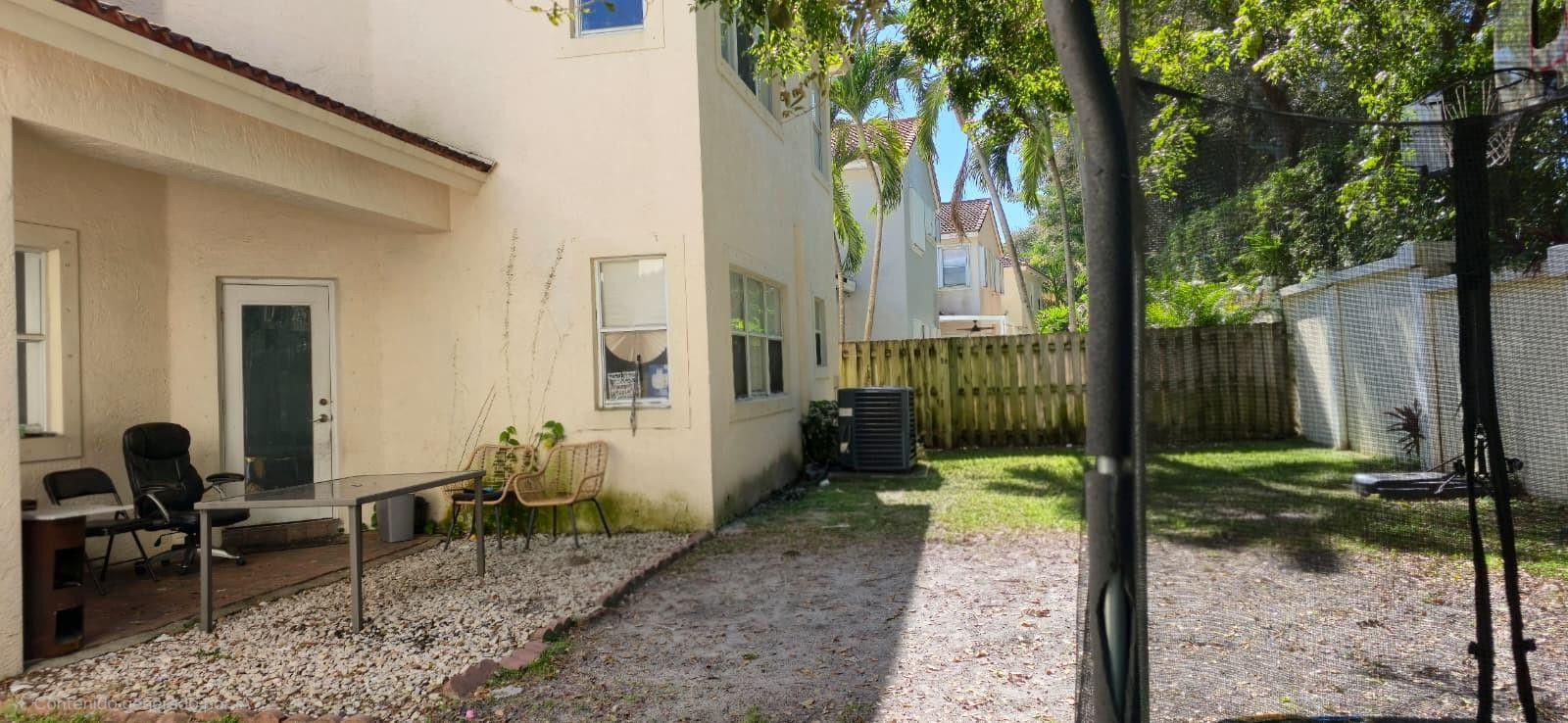 1888 Northwest 75th Way Hollywood, FL 33024 - Photo 5 of 45 a backyard of a house with table and chairs