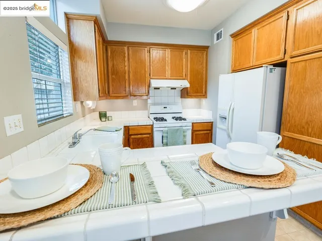 a kitchen with a table chairs and window