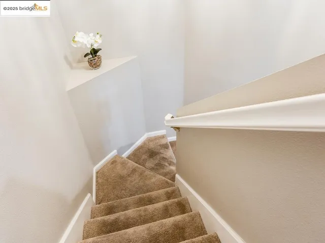 a view of staircase with white walls