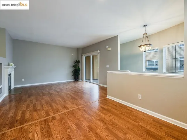a view of a livingroom with wooden floor and a window