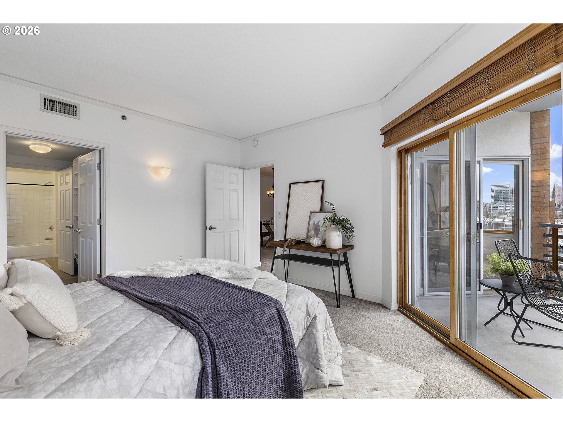 1132 Southwest 19th Avenue, Unit 505 Portland, OR 97205 - Photo 16 of 36 a bedroom with a bed and a table