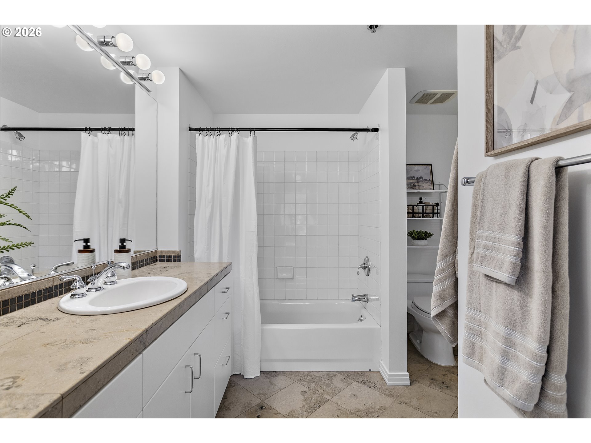 1132 Southwest 19th Avenue, Unit 505 Portland, OR 97205 - Photo 17 of 36 a bathroom with a granite countertop sink shower and a mirror