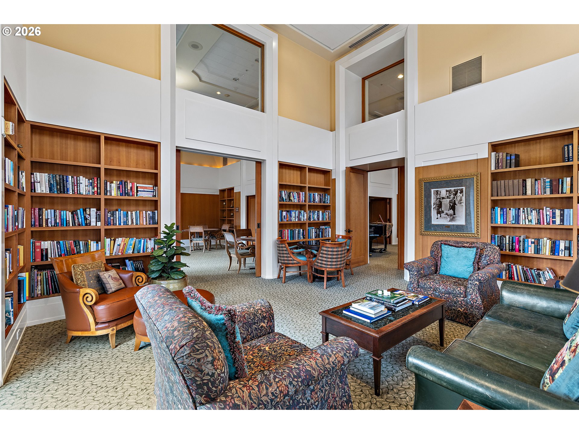 1132 Southwest 19th Avenue, Unit 505 Portland, OR 97205 - Photo 23 of 36 a living room with furniture a bookshelf and a table