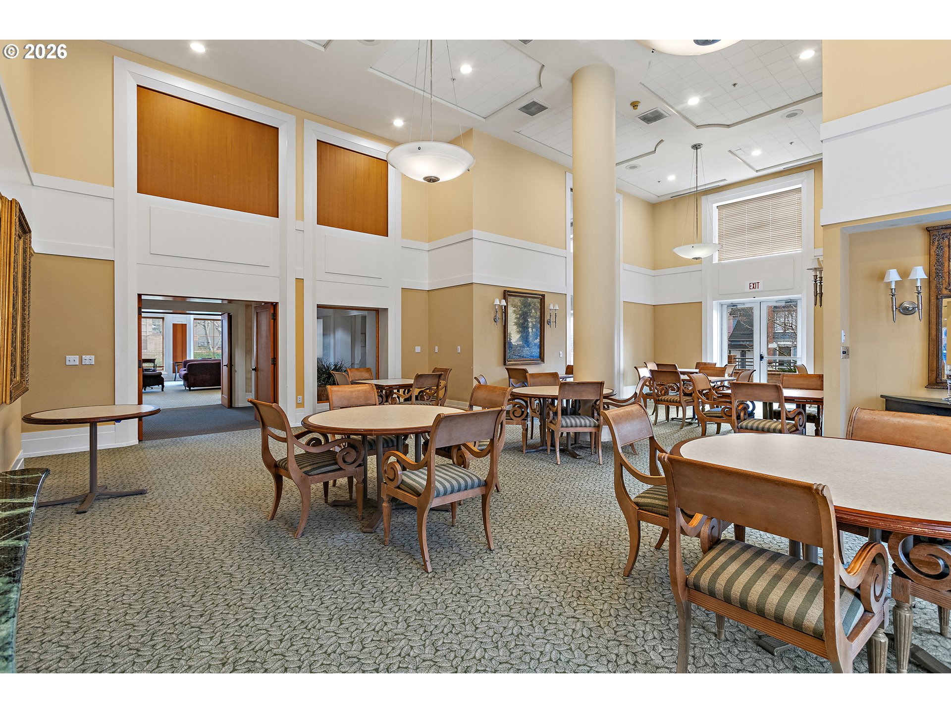 1132 Southwest 19th Avenue, Unit 505 Portland, OR 97205 - Photo 24 of 36 a view of a dining room and livingroom with furniture a rug a painting and a chandelier