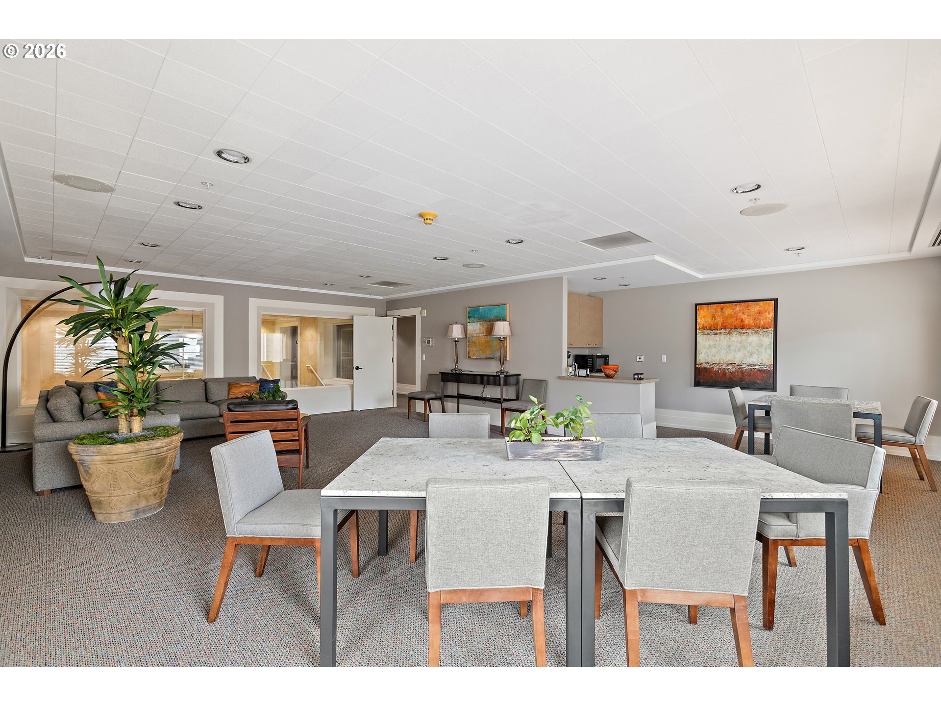 1132 Southwest 19th Avenue, Unit 505 Portland, OR 97205 - Photo 30 of 36 a view of a dining room with furniture and a potted plant