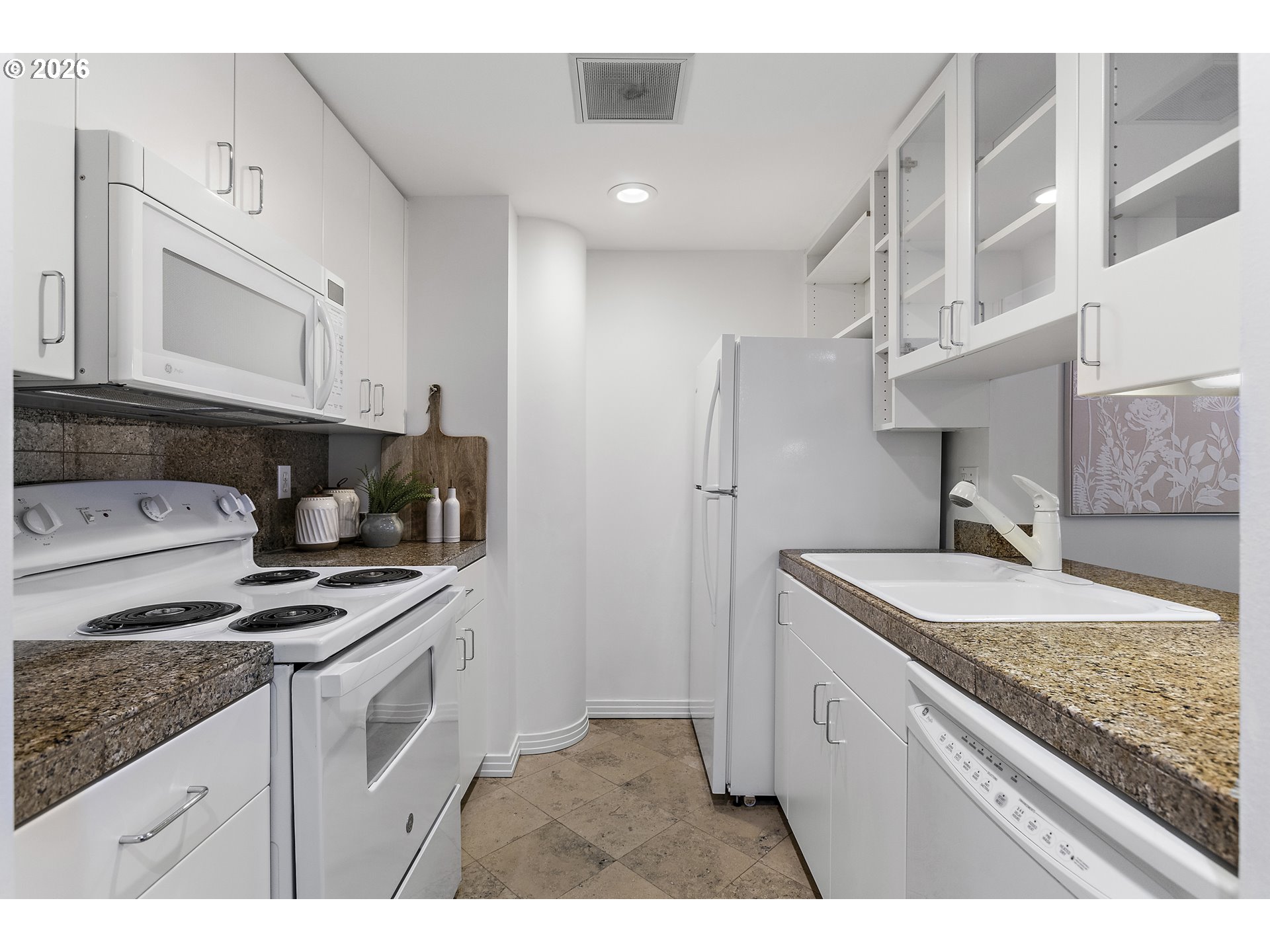 1132 Southwest 19th Avenue, Unit 505 Portland, OR 97205 - Photo 4 of 36 a kitchen with stainless steel appliances granite countertop a sink stove and refrigerator