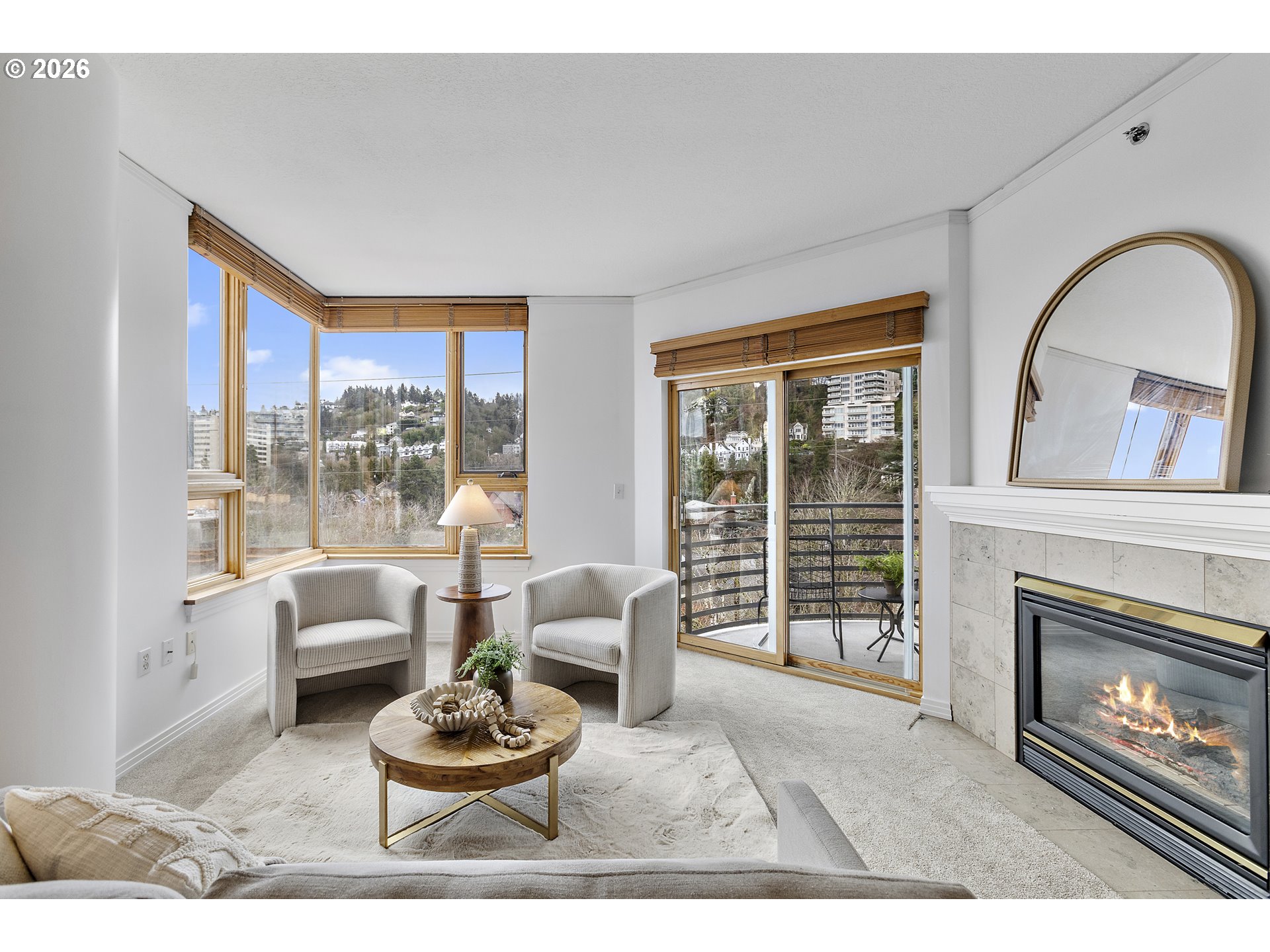 1132 Southwest 19th Avenue, Unit 505 Portland, OR 97205 - Photo 6 of 36 a living room with furniture a window and a fireplace