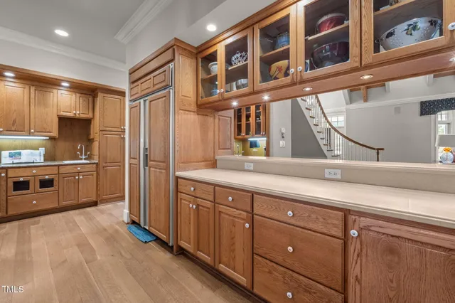 a kitchen with stainless steel appliances granite countertop a refrigerator and a sink