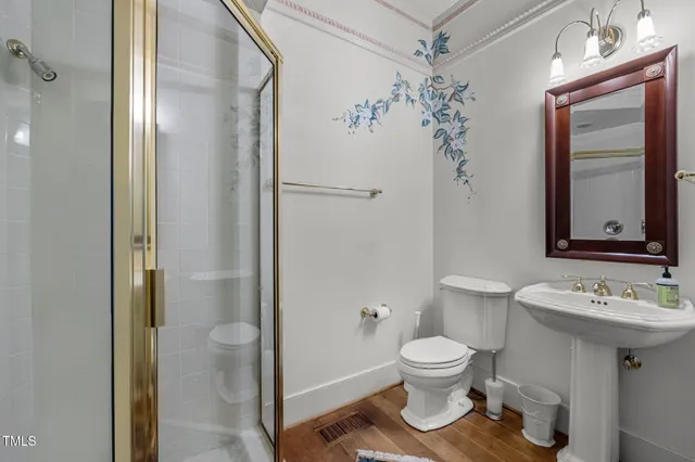 a bathroom with a toilet sink and shower