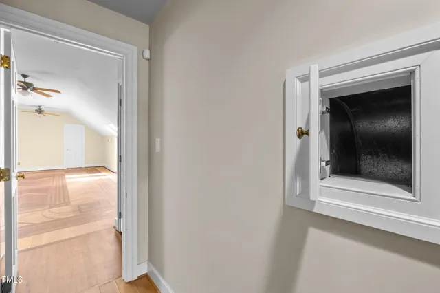 a view of entryway and hall with wooden floor