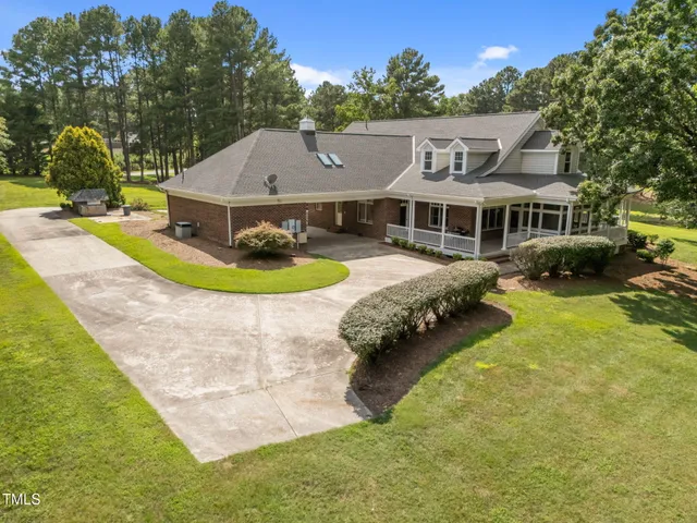a front view of a house with a garden and porch