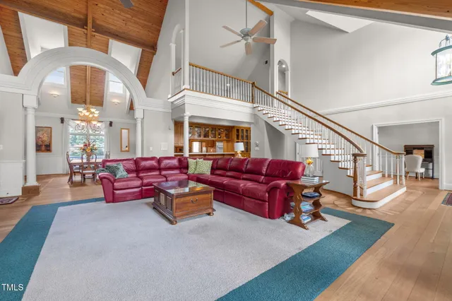 a living room with furniture chess board and wooden floor