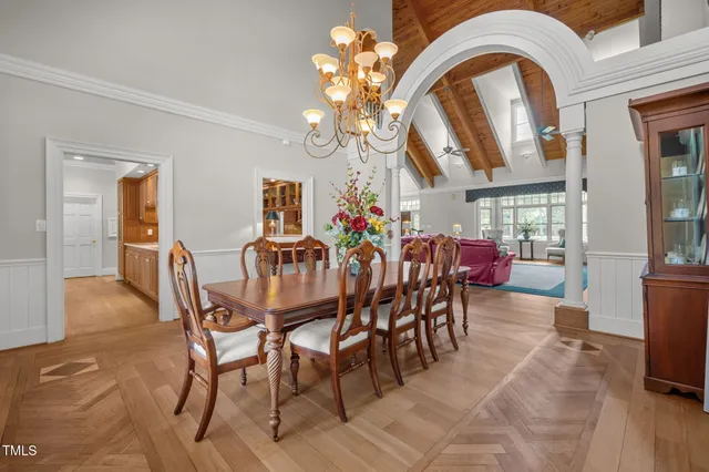 a view of a dining room with furniture and chandelier