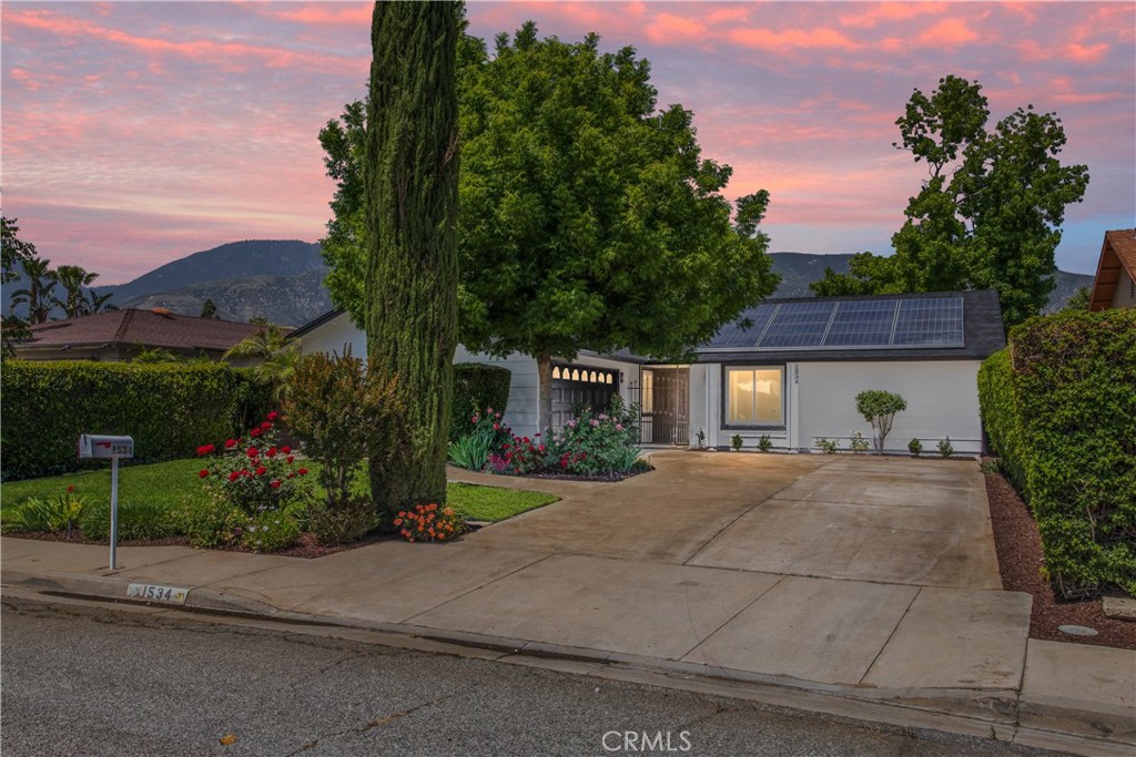 1534 Ranch Road San Bernardino, CA 92407 - Photo 1 of 1 a front view of a house with a yard and a garage