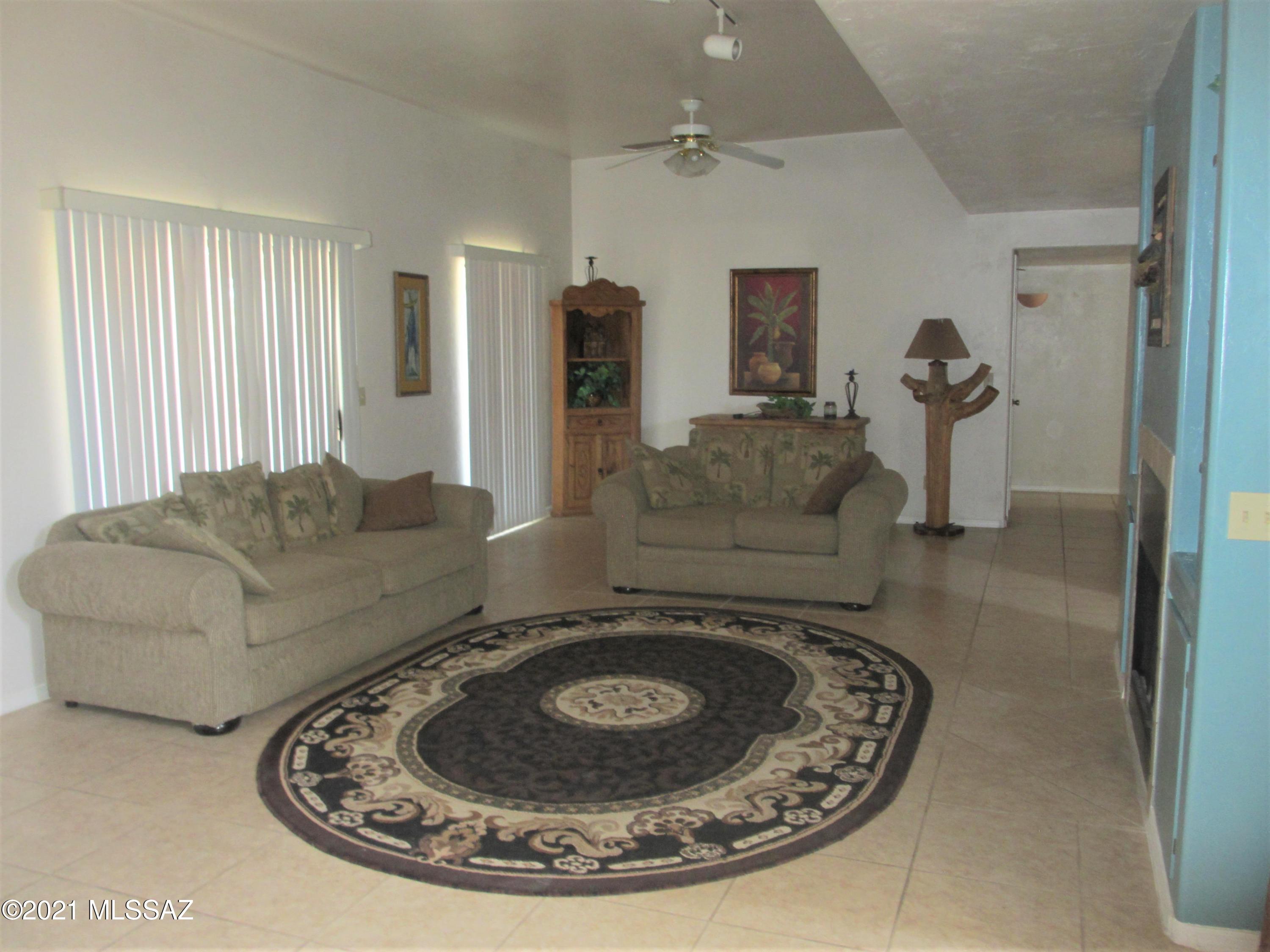 978 Calle Amarillo Rio Rico, AZ 85648 - Photo 21 of 34 a living room with furniture and a fireplace