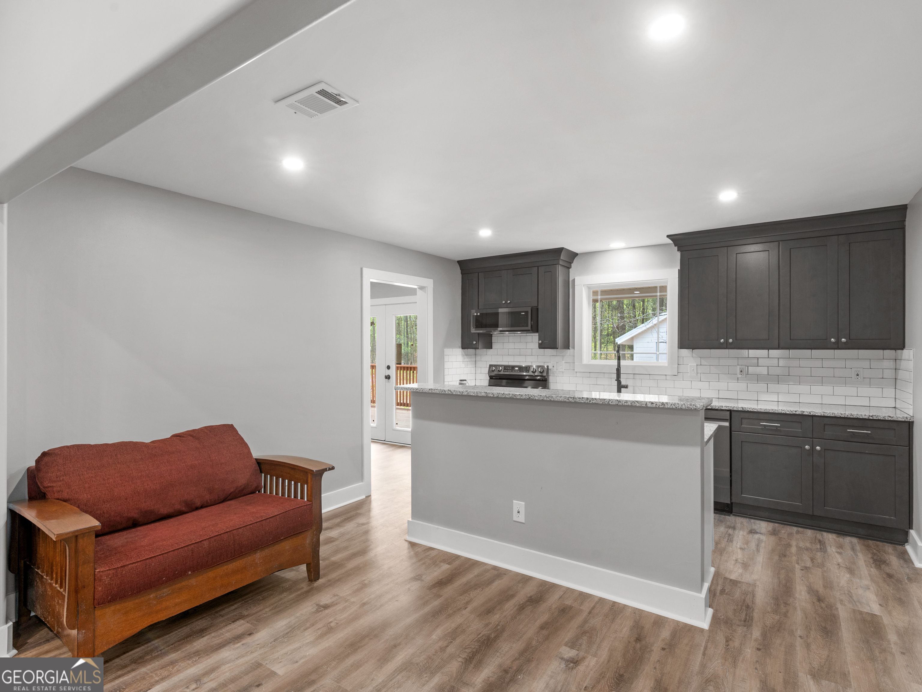 265 Steele Road Griffin, GA 30223 - Photo 12 of 64 a living room with stainless steel appliances granite countertop furniture and a wooden floors