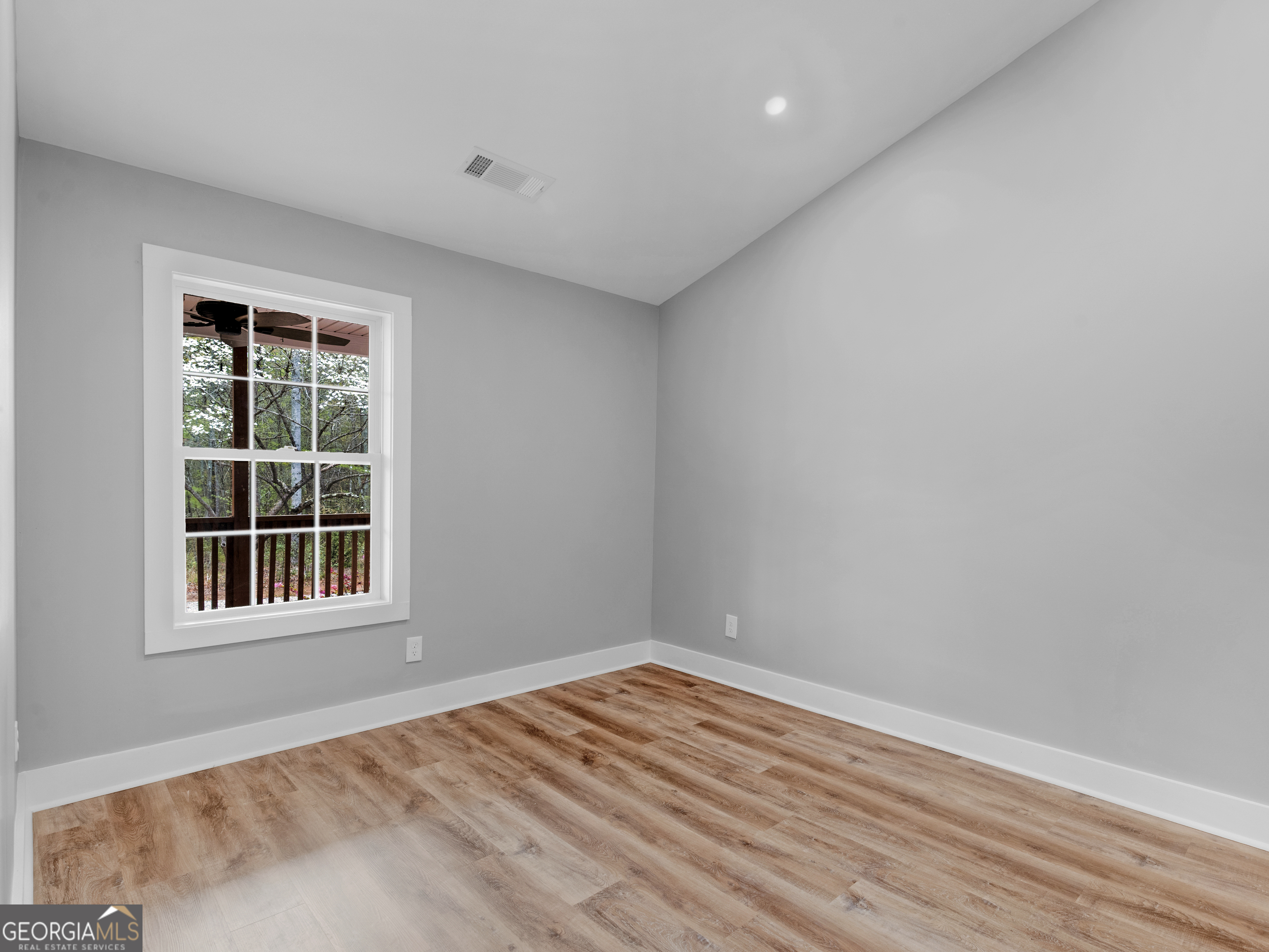 265 Steele Road Griffin, GA 30223 - Photo 20 of 64 a view of empty room with wooden floor and fan