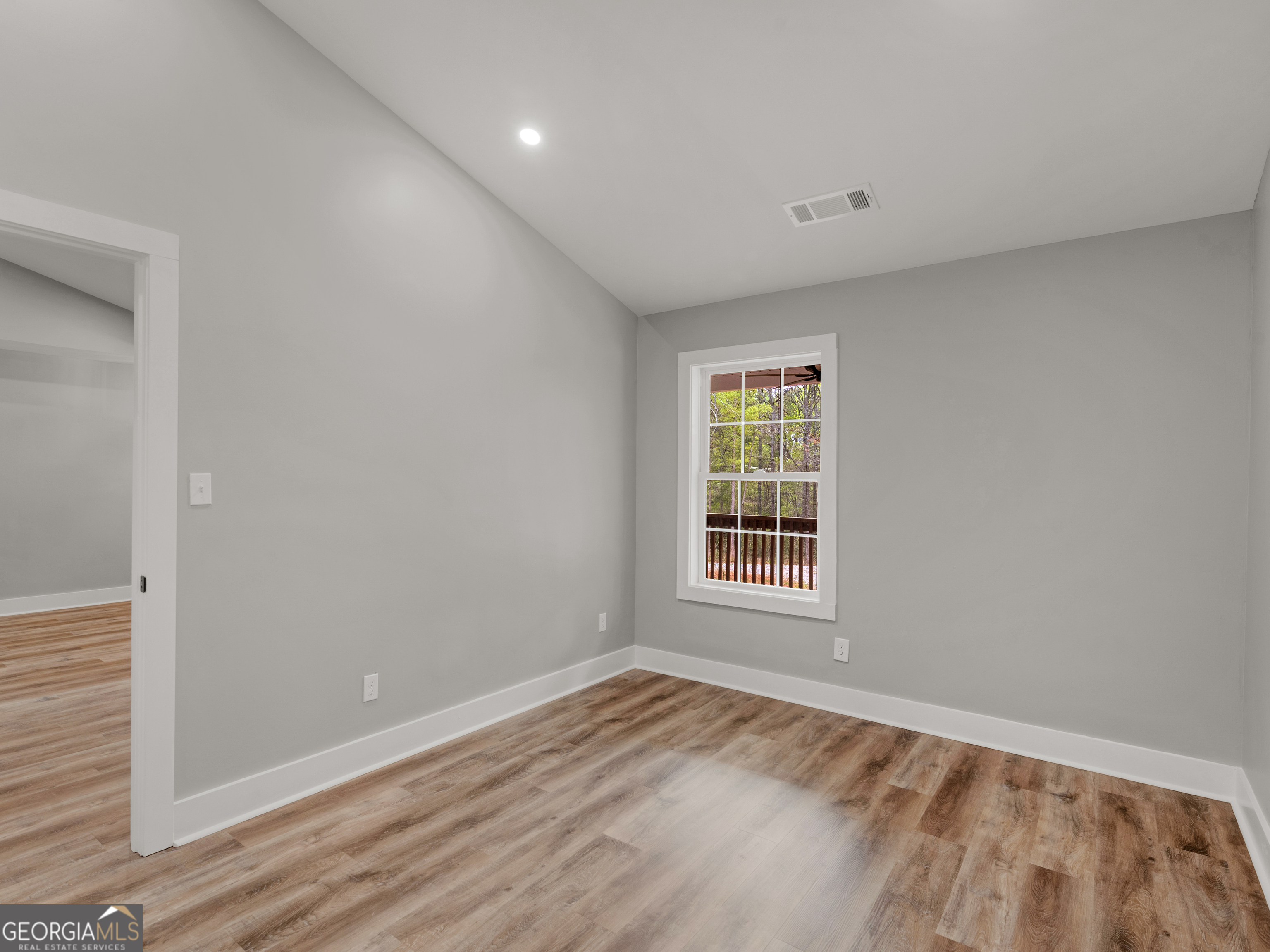 265 Steele Road Griffin, GA 30223 - Photo 21 of 64 a view of empty room with wooden floor and fan