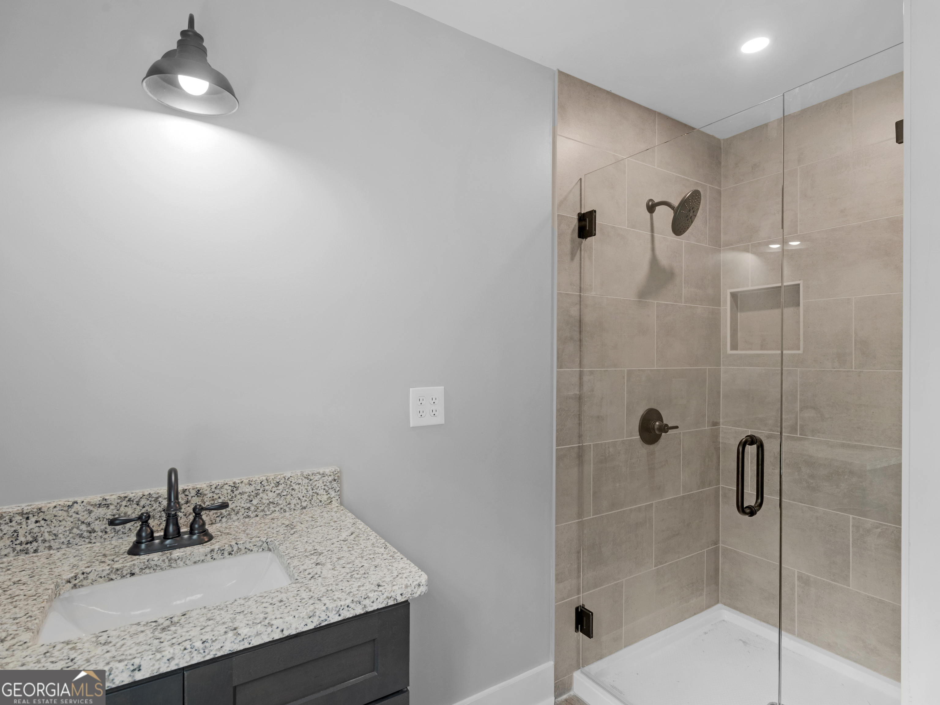 265 Steele Road Griffin, GA 30223 - Photo 25 of 64 a bathroom with a granite countertop sink a mirror and shower