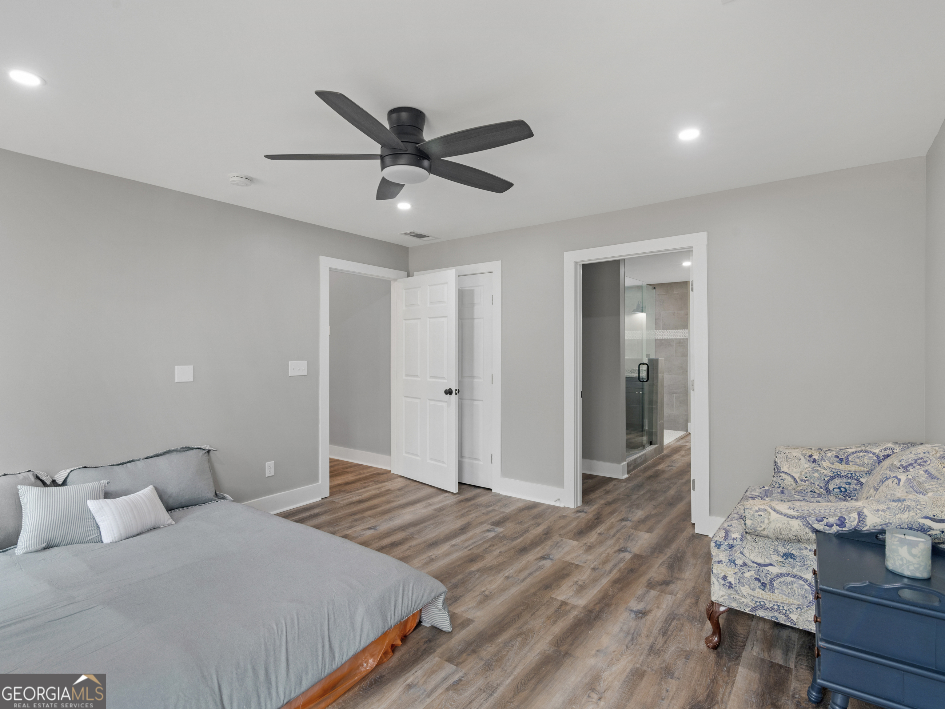 265 Steele Road Griffin, GA 30223 - Photo 28 of 64 a spacious bedroom with a bed and a chandelier