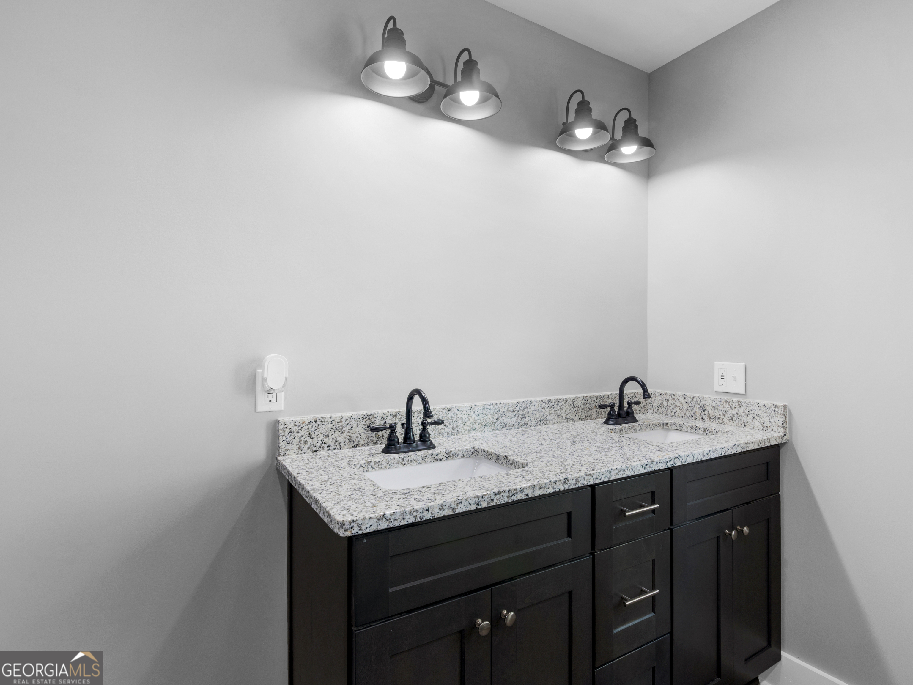265 Steele Road Griffin, GA 30223 - Photo 32 of 64 a bathroom with a granite countertop sink a mirror and vanity