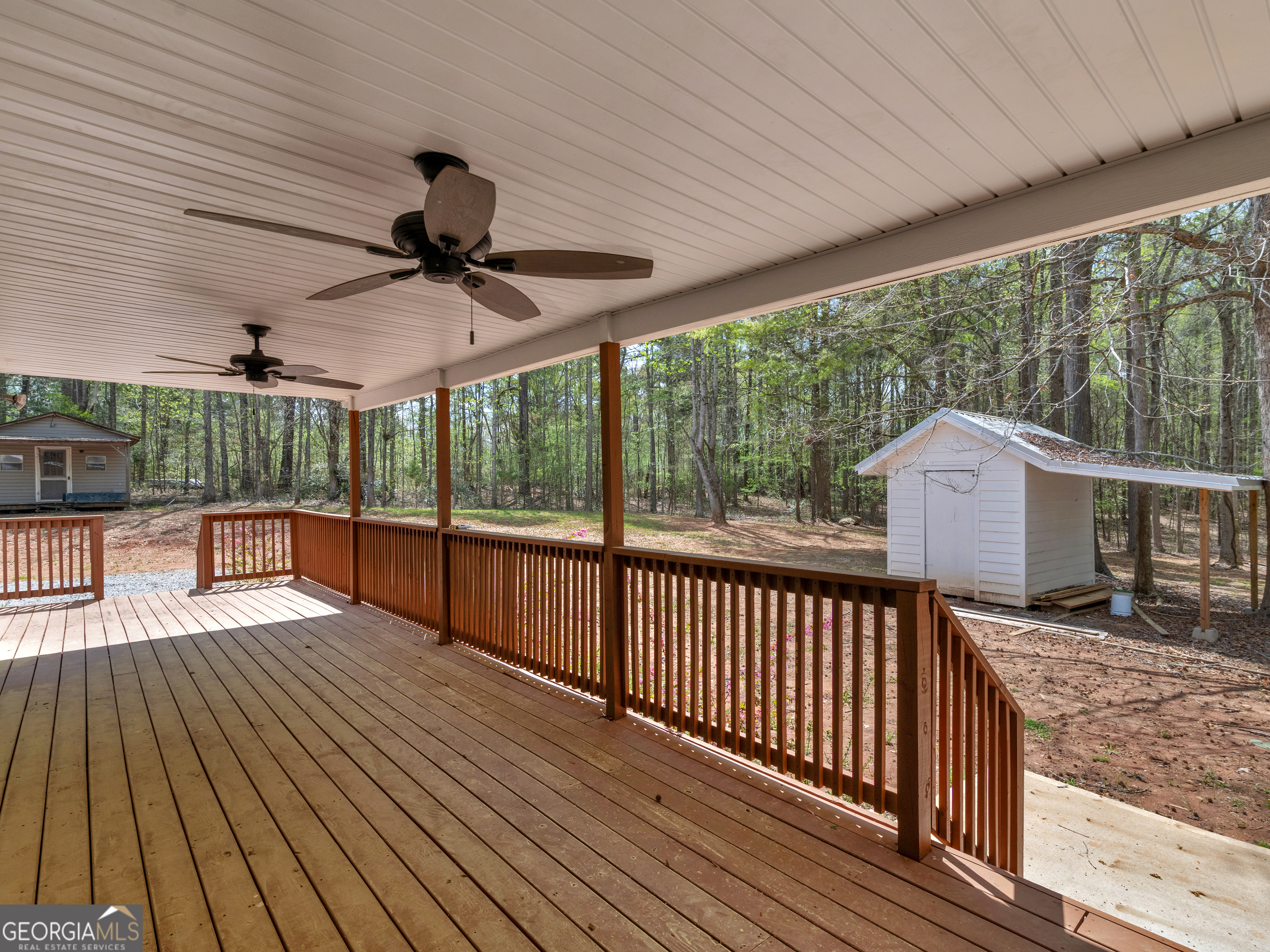 265 Steele Road Griffin, GA 30223 - Photo 35 of 64 a view of backyard with a deck and wooden floor