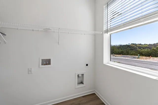 a view of a small space with wooden floor and a window