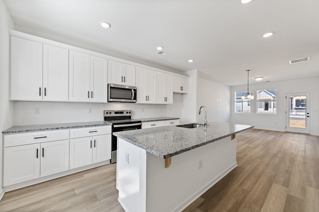 32 Grove Loop Blue Ridge, GA 30513 - Photo 26 of 47 a kitchen with granite countertop white cabinets and stainless steel appliances