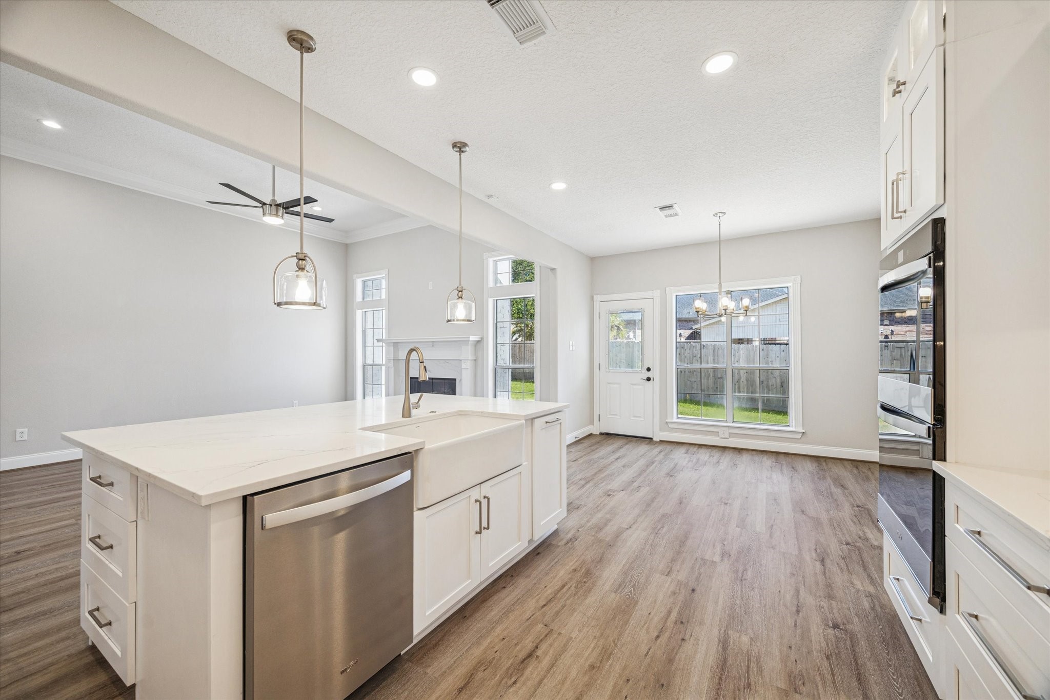5437 Edgewater Court Willis, TX 77318 - Photo 10 of 29 a kitchen with a wooden floor and white appliances