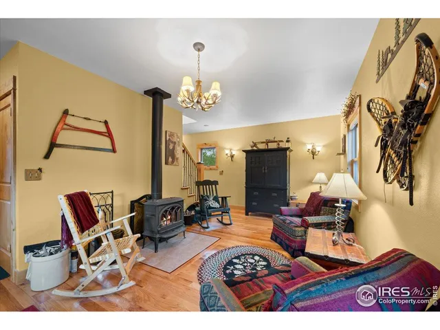 a living room with dining table and a chandelier