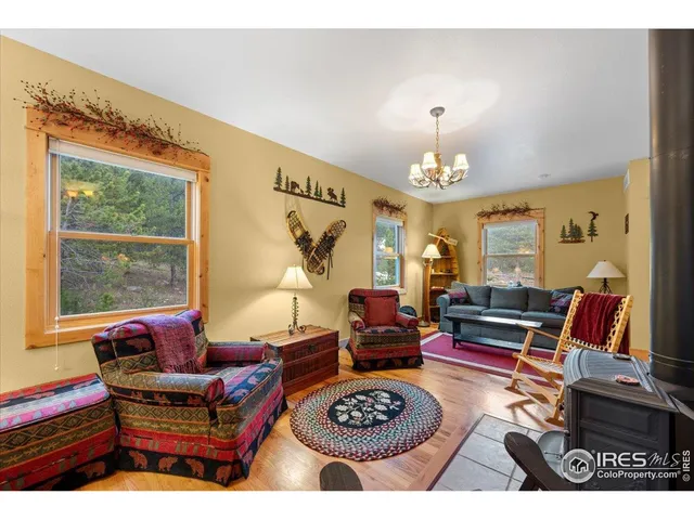 a living room with furniture a rug and a chandelier