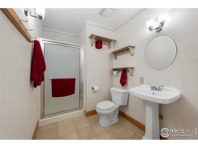 a bathroom with a sink toilet and a mirror