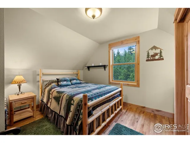 a bedroom with a bed next to a window