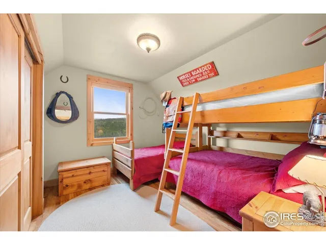 a bedroom with furniture and a wooden floor