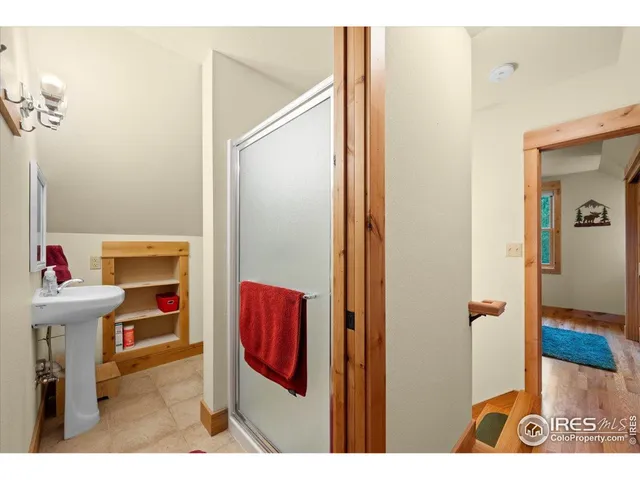 a view of bathroom with a sink and a mirror