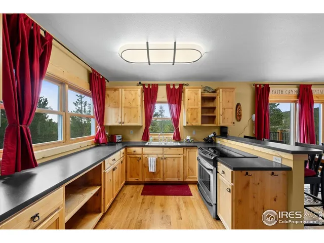 a kitchen with stainless steel appliances granite countertop a stove and a sink